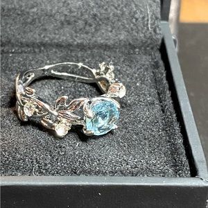 Sterling silver band with auquamarine stone and small white stones